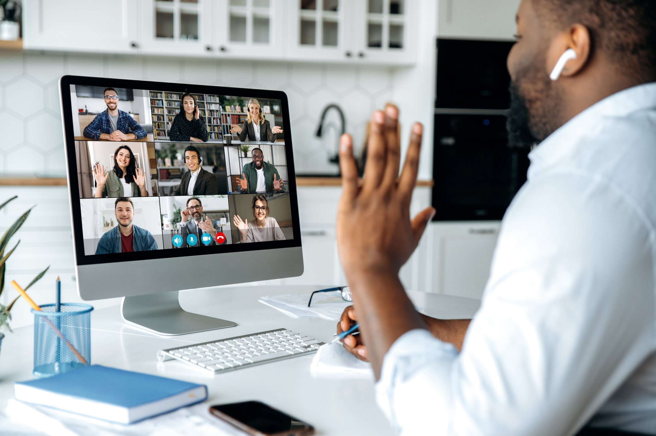 Man having a video conference with his colleagues creating a virtual watercooler moment